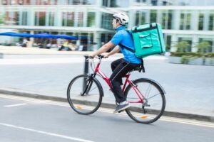 Man riding bicycle and delivering food