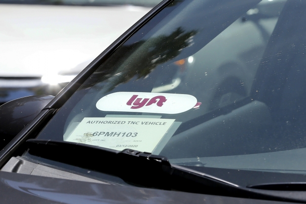 Close up of a Lyft ride-share car as it waits at a stoplight in Sacramento, CA.